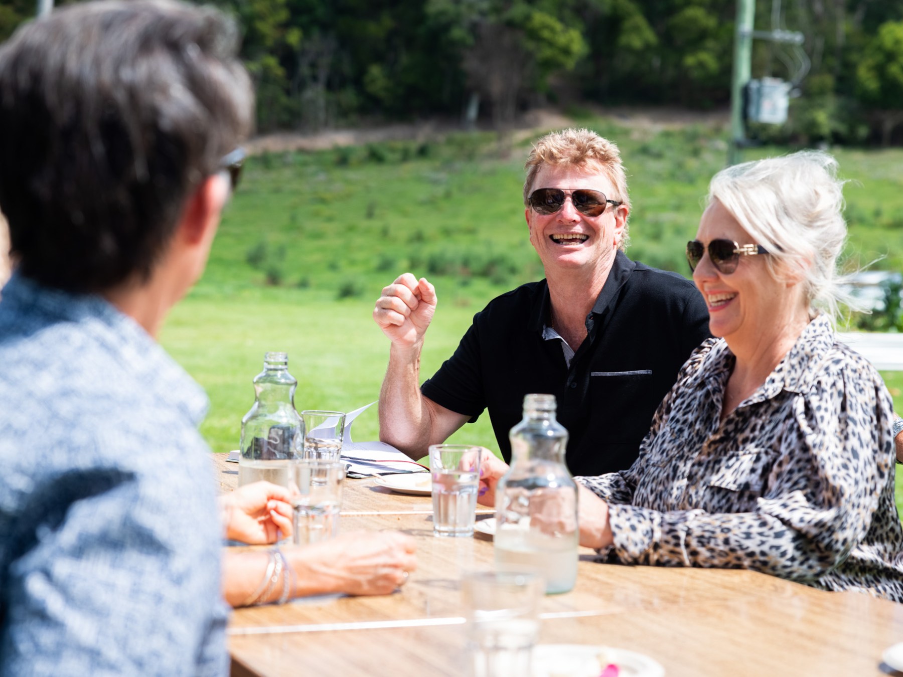 a group of people sitting at a table with wine glasses