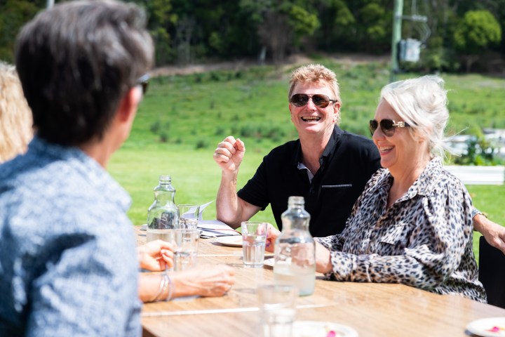 a group of people sitting at a table with wine glasses