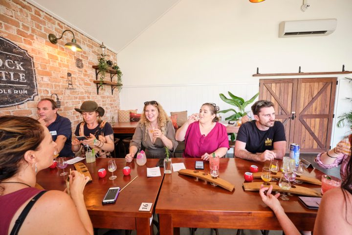 a group of people sitting at a table with wine glasses