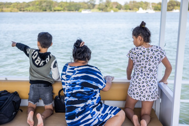 a little boy that is sitting in the water