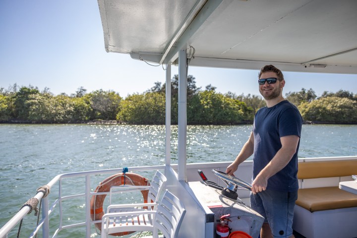 a man standing on a boat in the water