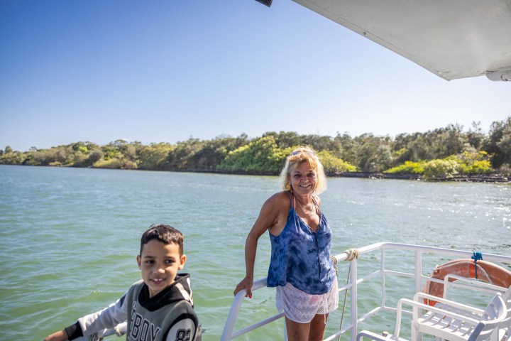 a group of people standing next to a body of water