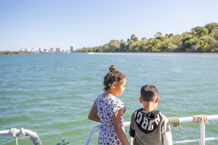 a group of people in a boat on a body of water