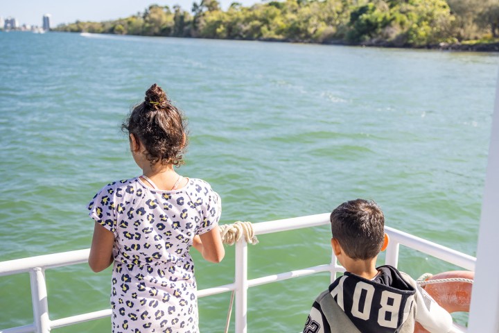 a group of people in a boat on a body of water