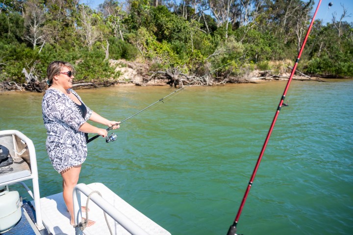 a person standing next to a body of water