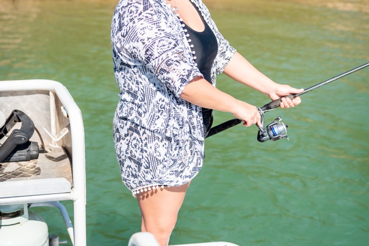 a person riding on the back of a boat in the water