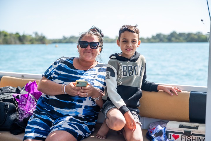 a person sitting on a boat in a body of water