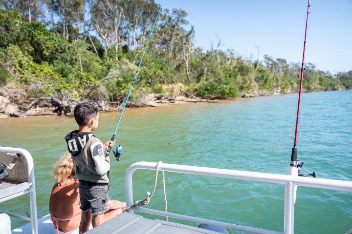 a person standing next to a body of water