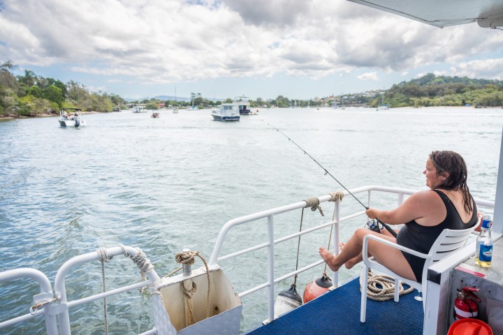 a person sitting on a boat in a body of water