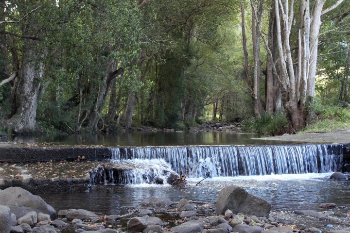 a waterfall going over a body of water
