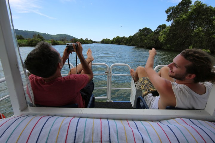 a person sitting next to a body of water