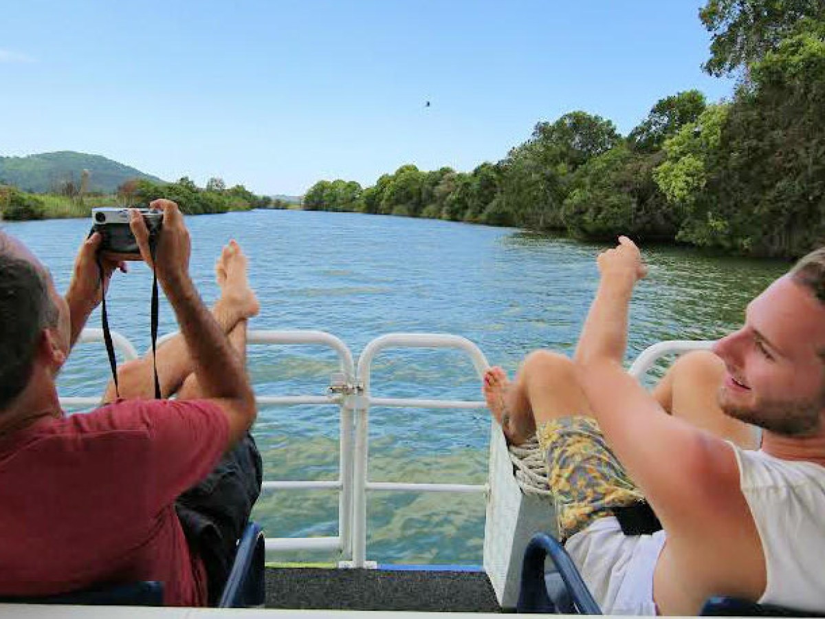 a group of people sitting in front of a body of water