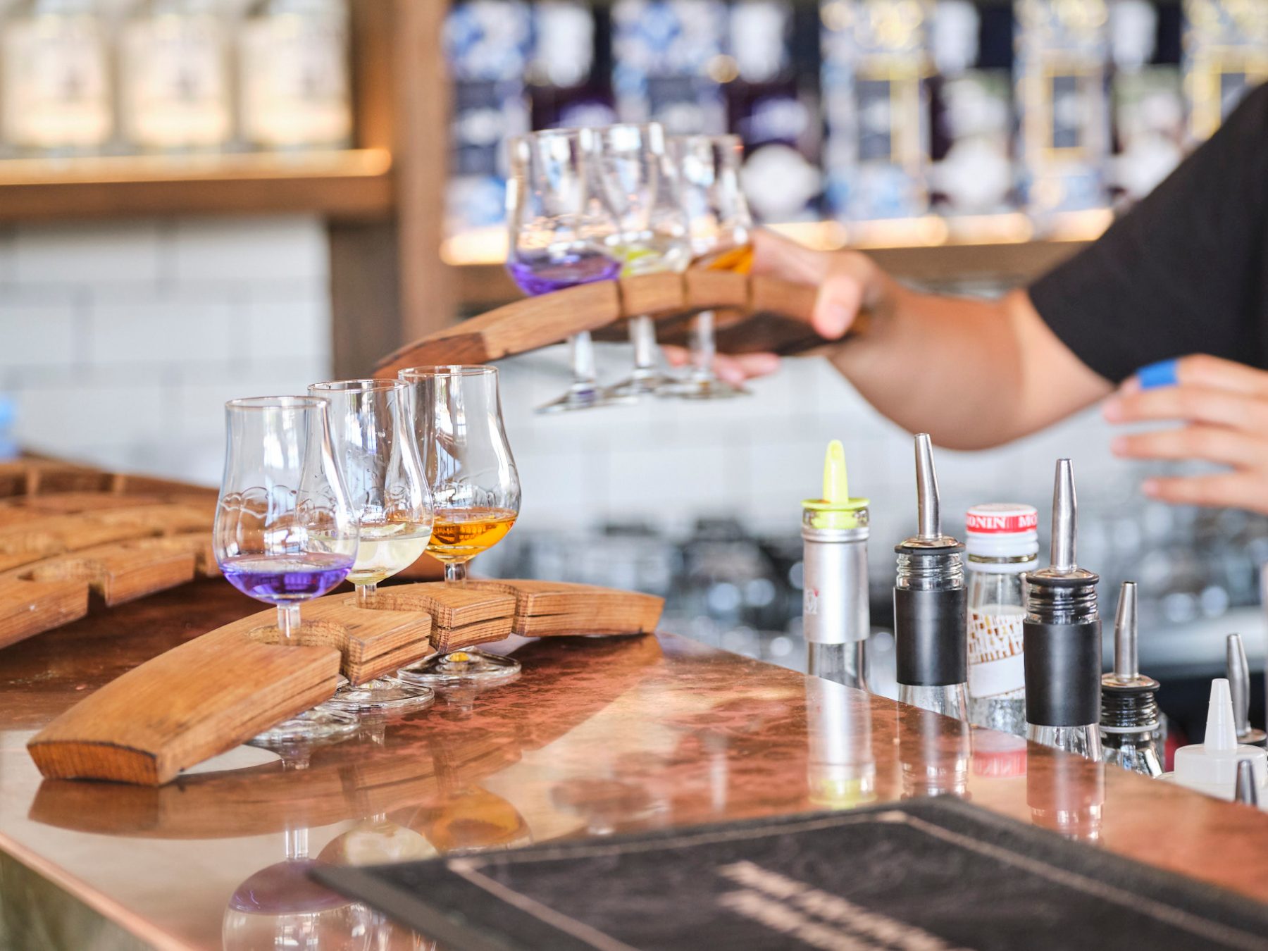a person sitting at a table with wine glasses