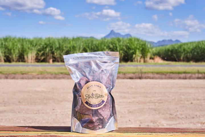 a sign on the side of a dirt field