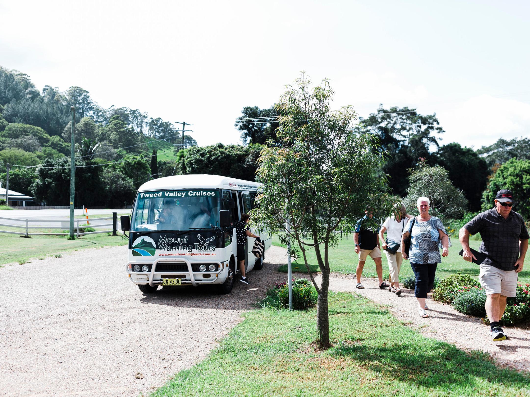 a group of people standing on top of a dirt road