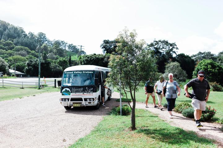 a group of people standing on top of a dirt road