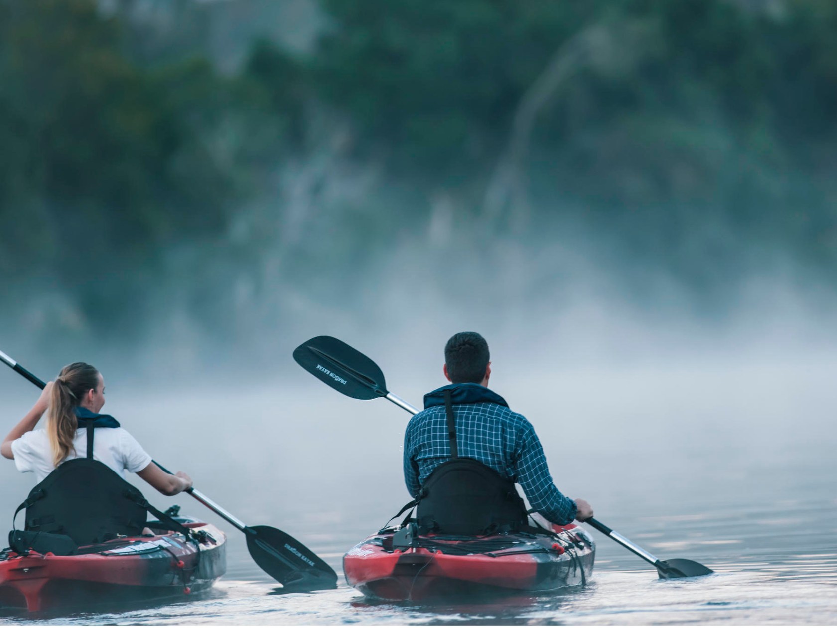 a man riding on the back of a boat in the water