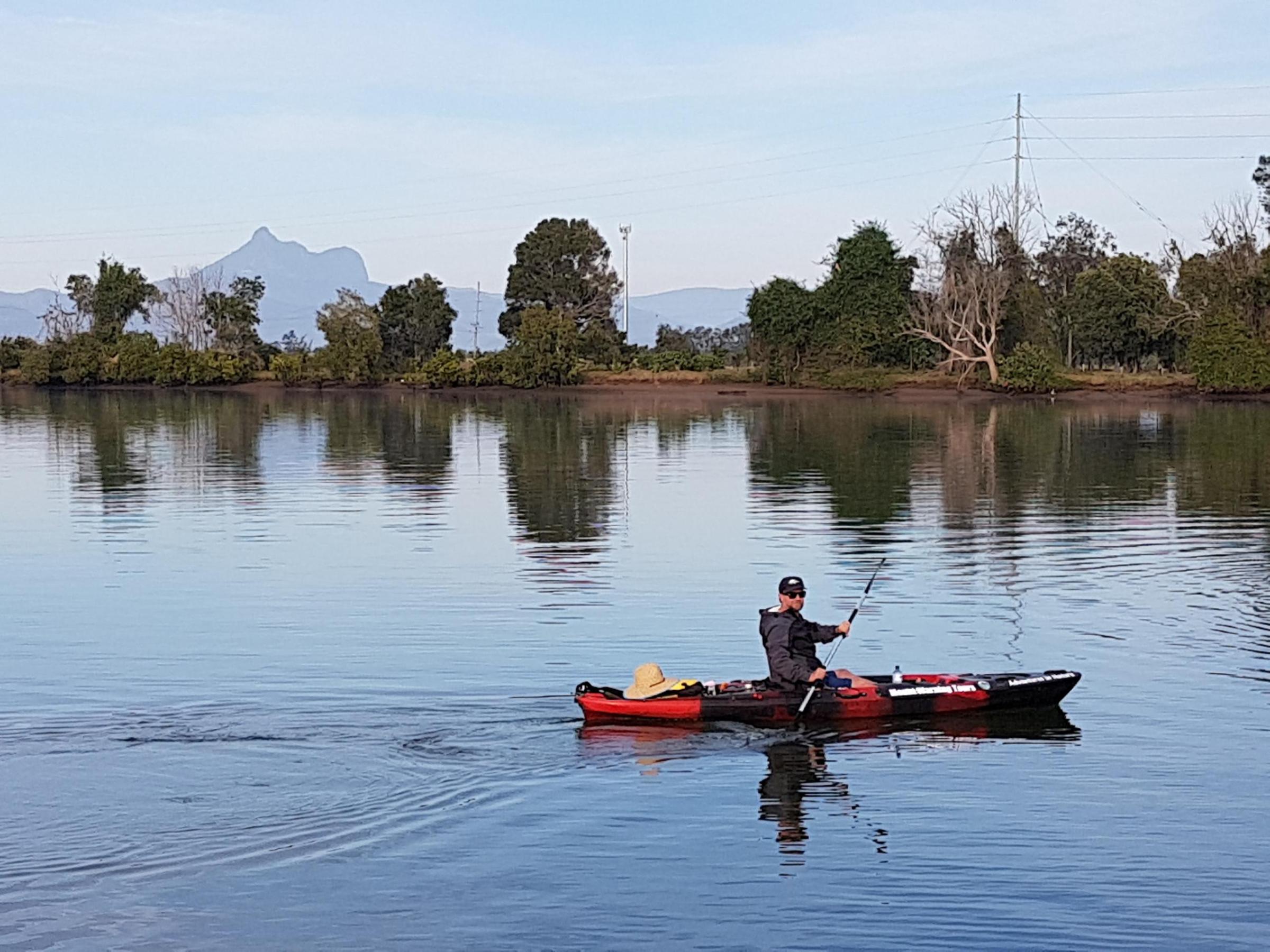 a group of people in a small boat in a body of water