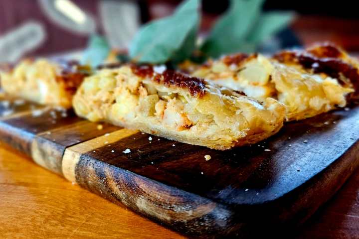 a slice of pizza sitting on top of a wooden table