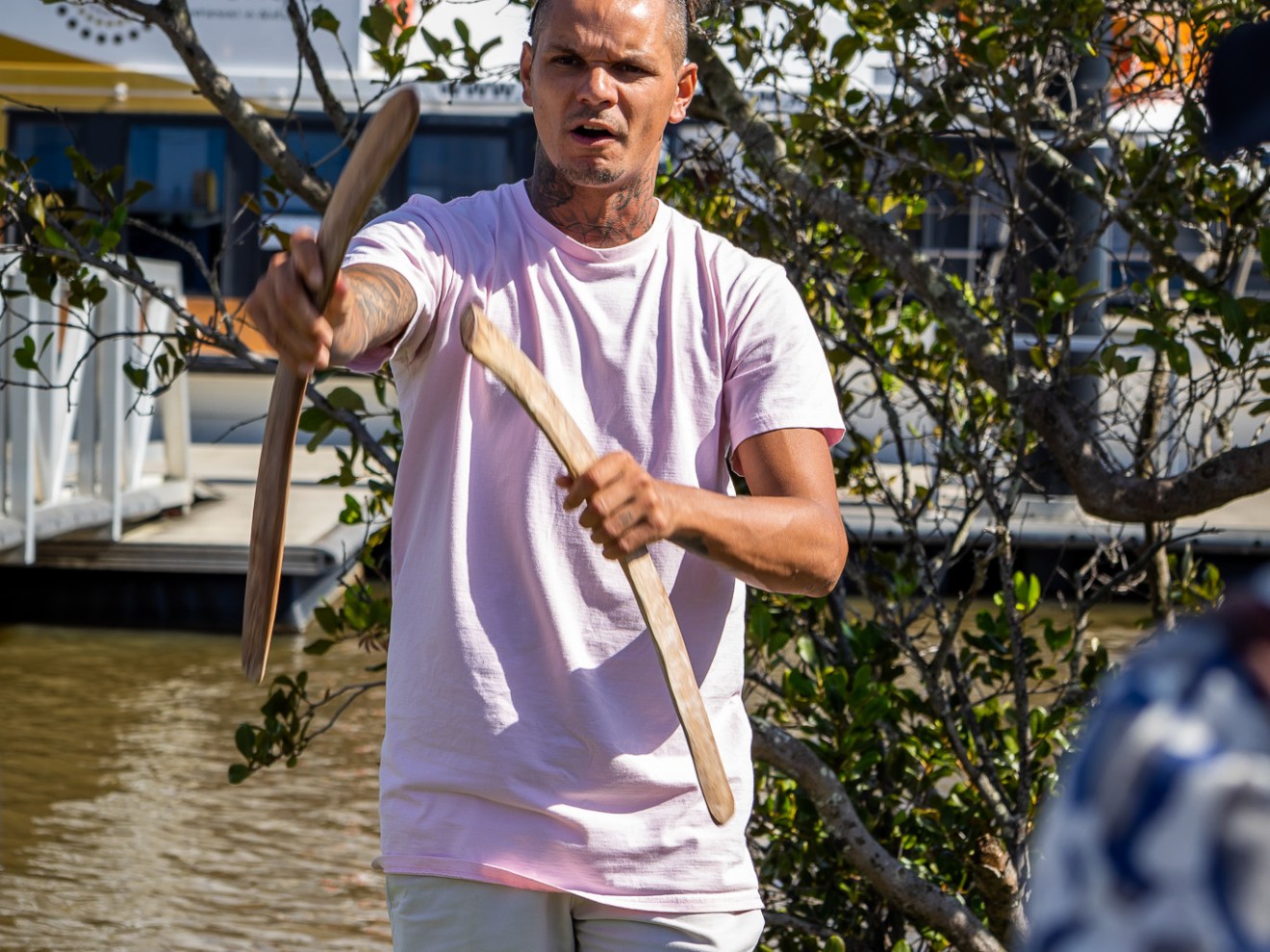 a man standing next to a tree