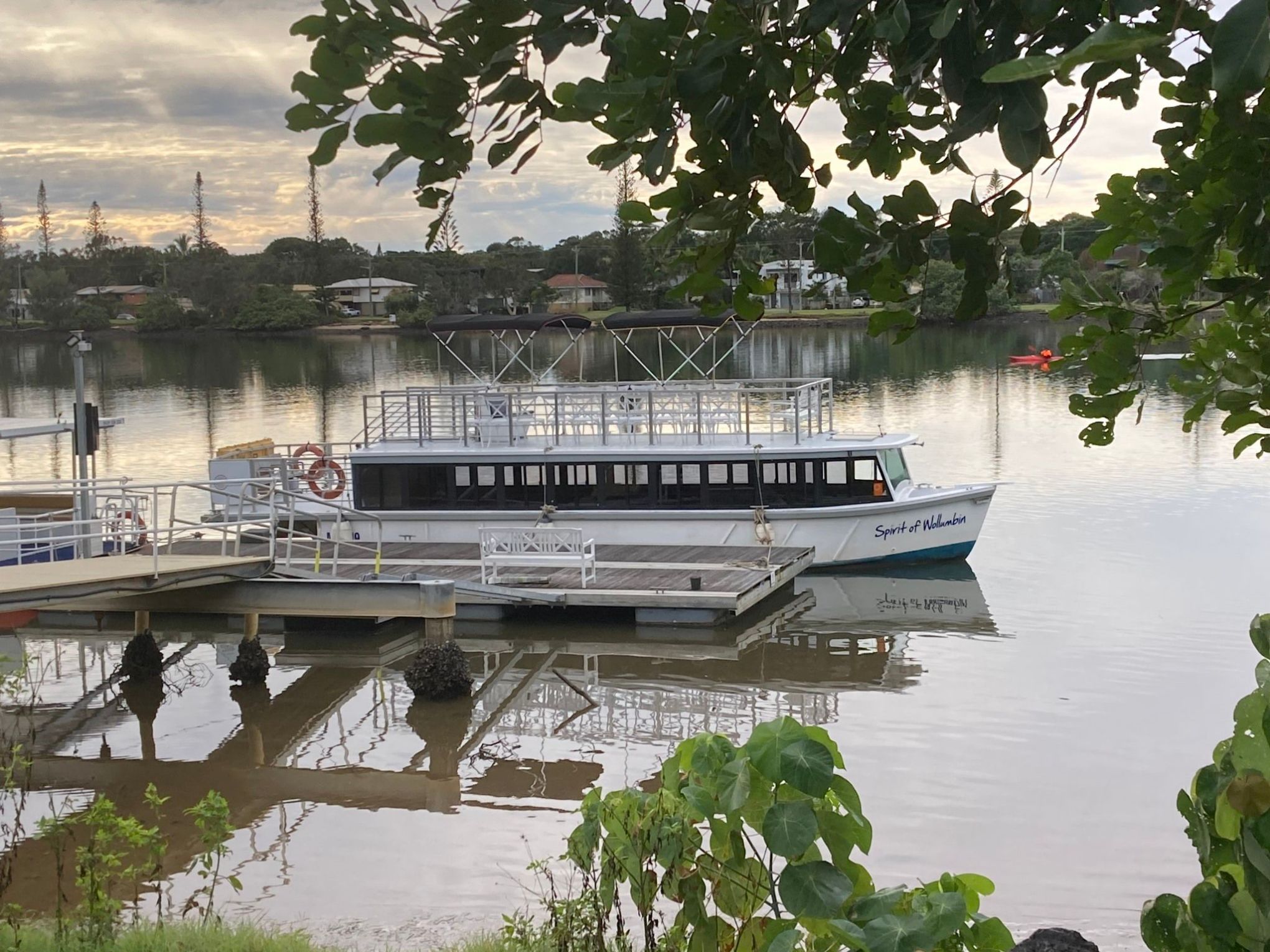 a boat traveling across a bridge over a body of water
