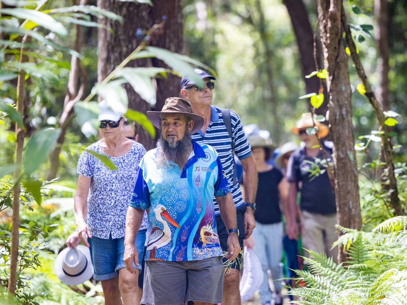 a group of people standing next to a tree