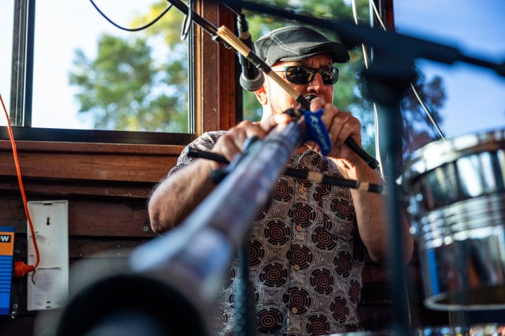 a man standing in front of a mirror posing for the camera