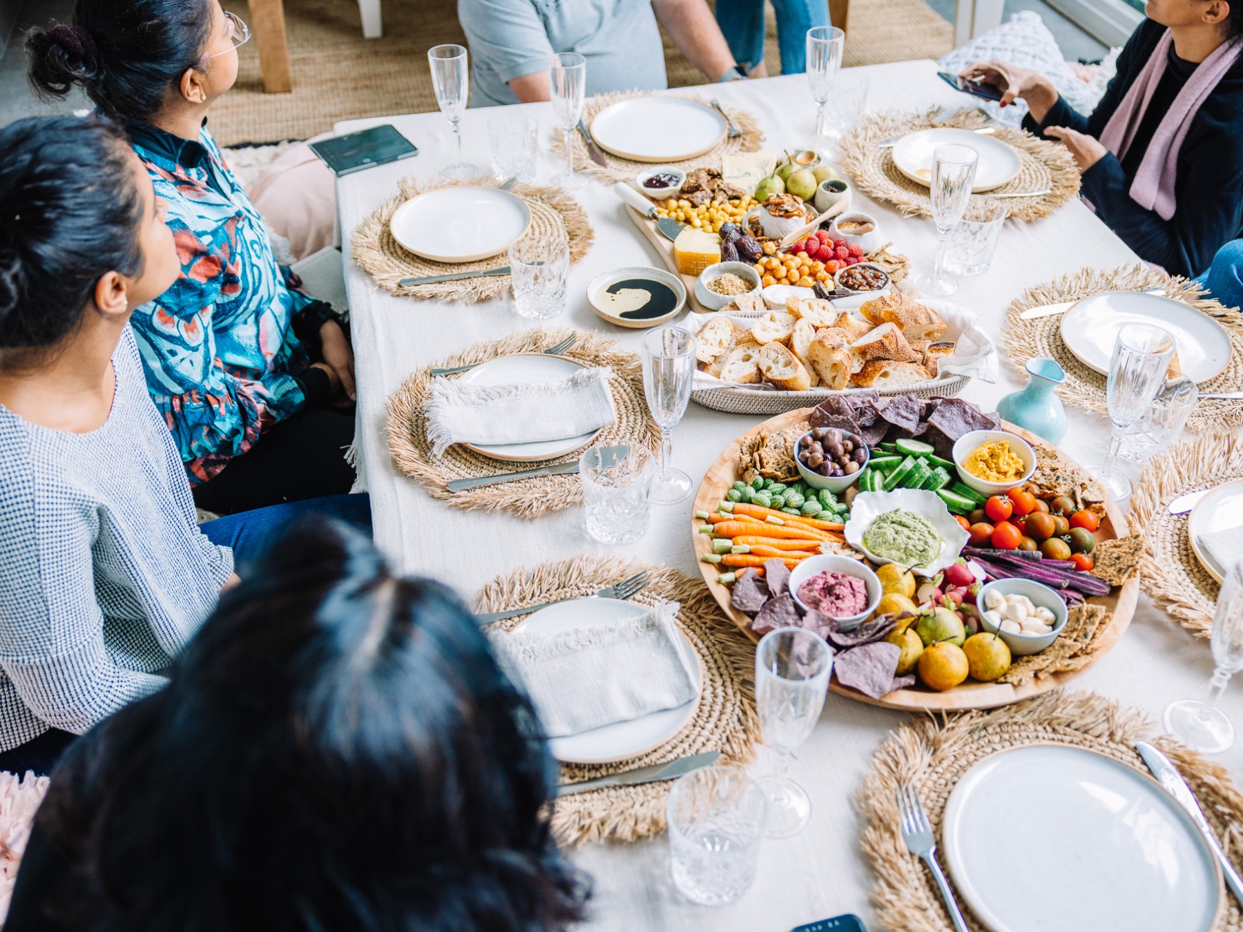 a group of people sitting at a table with a plate of food