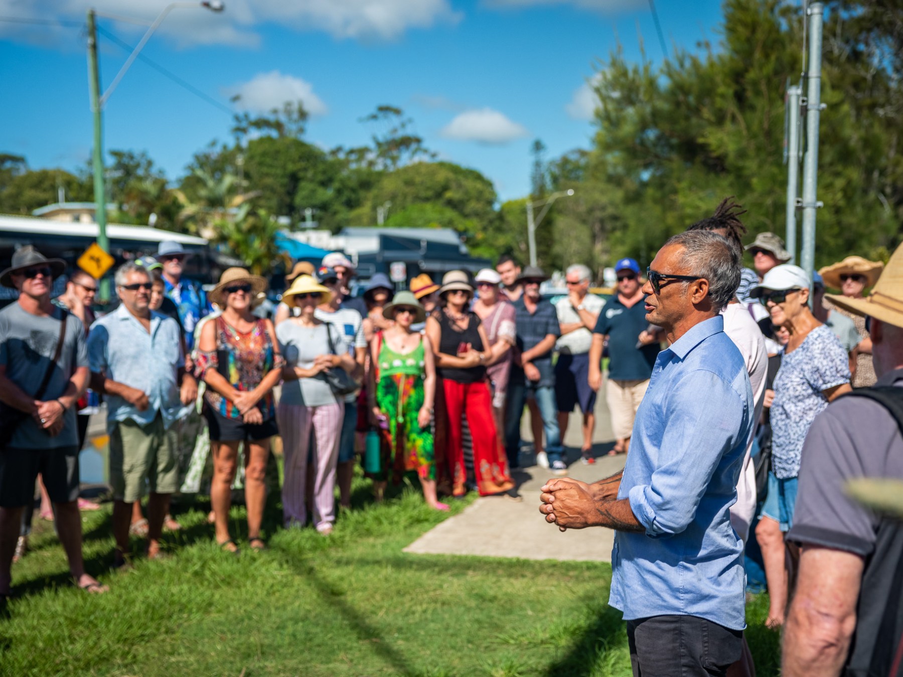 a group of people that are standing in the grass